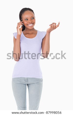 Close up of smiling woman talking on the phone on white background