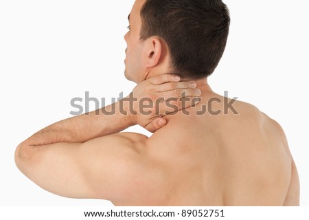 Young man experiencing neck pain against a white background