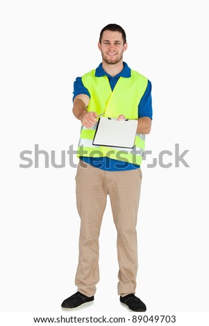 Smiling male in safety jacket handing his notes over against a white background