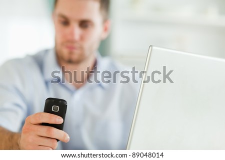 Mobile phone being used by young businessman