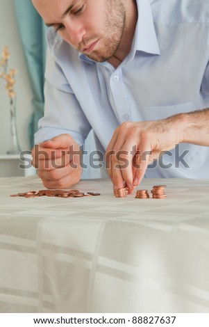 Desperate young businessman counting his small change