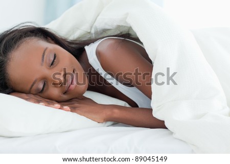 Happy woman sleeping in her bedroom