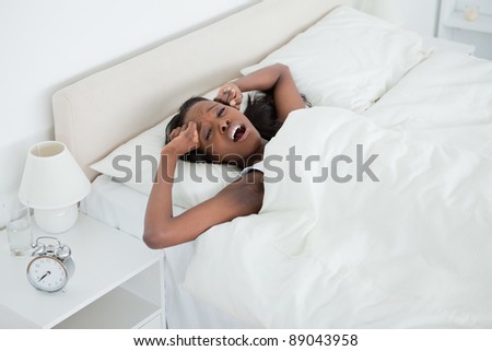 Exhausted woman waking up in her bedroom
