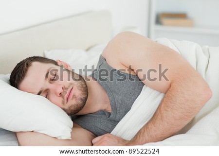 Handsome man sleeping in his bedroom