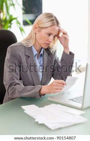 Worried businesswoman doing accounting