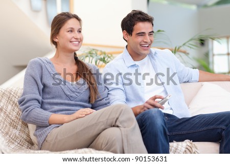 Couple watching TV in their living room