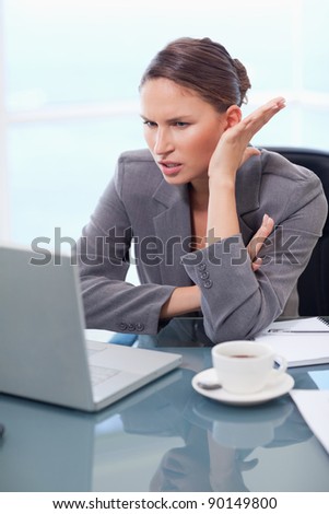 Portrait of an angry businesswoman working with a notebook in her office