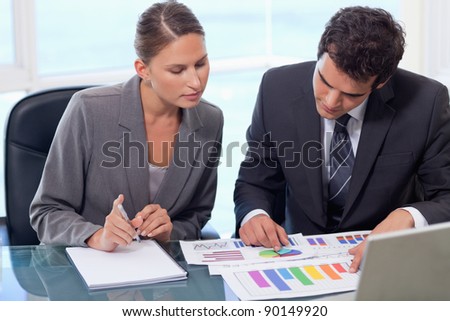 Business team studying statistics in a meeting room