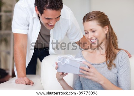 Young woman happy about the present she got from her boyfriend