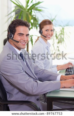 Side view of smiling call center agents