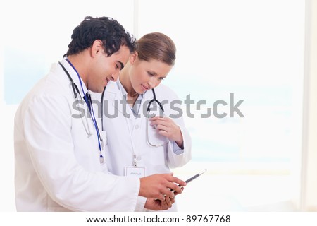 Young medical staff looking at clip board