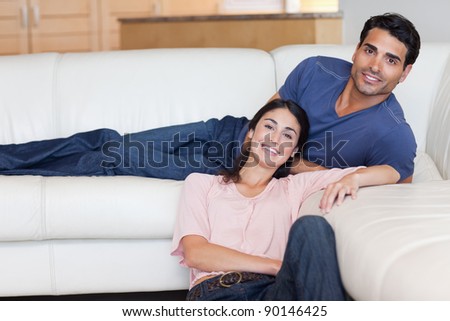 Smiling couple posing in their living room