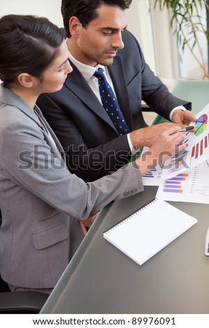 Portrait of young sales persons studying statistics in an office