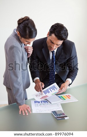 Portrait of focused sales persons studying statistics in an office