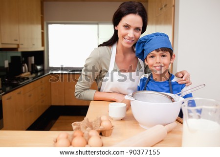Mother and son preparing cake together