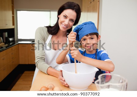 Mother and son having fun preparing dough together