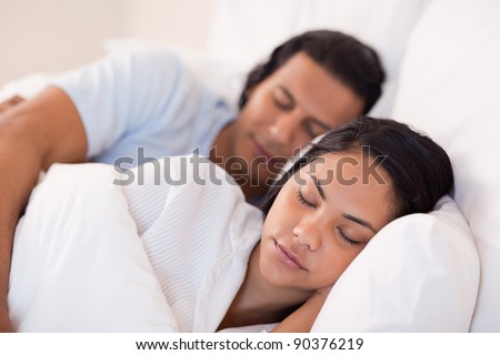 Side view of young couple being asleep