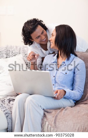 Young couple surfing the internet on the sofa