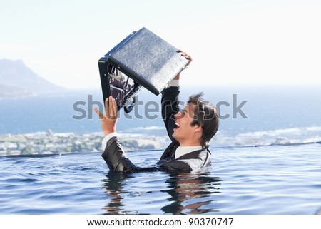 Businessman looking in his briefcase in a swimming pool