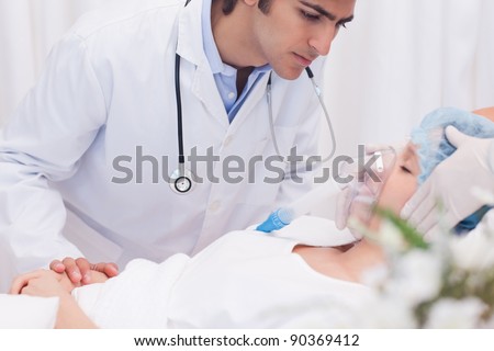 Male doctor examining intensive care patient