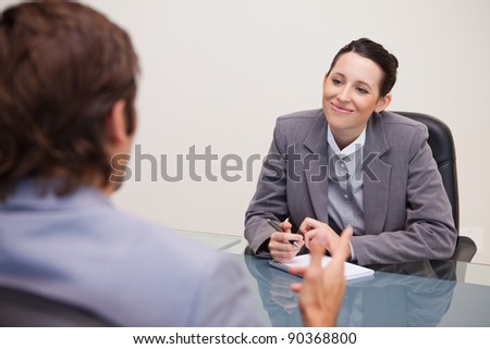 Smiling young businesswoman in a meeting