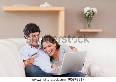 Young couple on the sofa shopping online