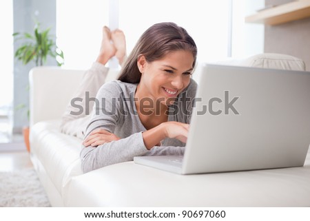 Young woman on the sofa chatting online