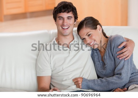 Happy young couple enjoying their time together on the sofa