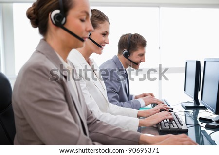 Side view of customer service employees at work