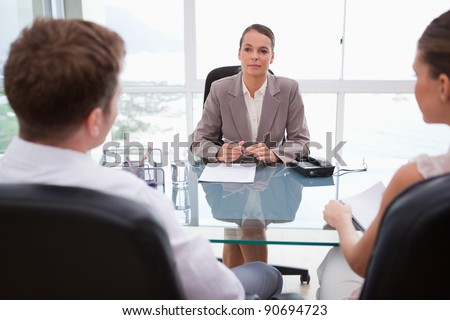 Lawyer advising her clients in her office