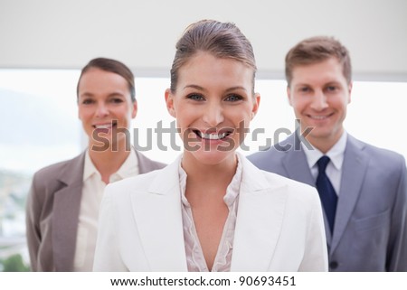Marketing manager standing with her team behind her