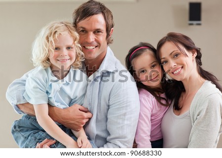Lovely family posing together while looking at the camera