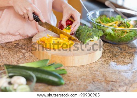 Woman preparing healthy green salad