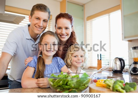 Family standing together behind the kitchen counter