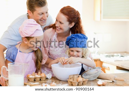 Happy young family enjoys baking together