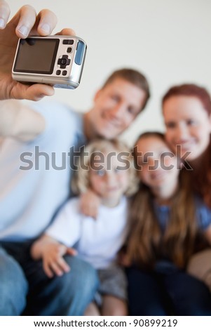 Digi cam being used by father to take family picture