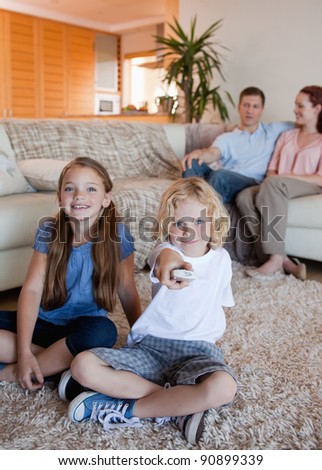 Family watching television in the living room together