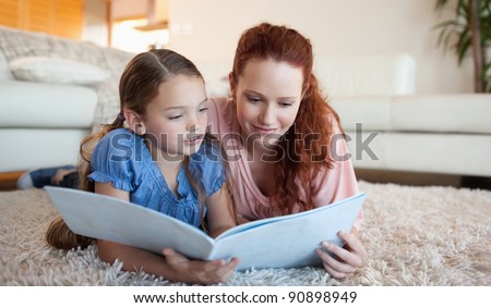 Mother and daughter looking at a magazine together