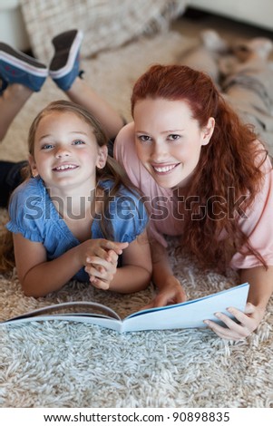 Mother and daughter on the floor reading together
