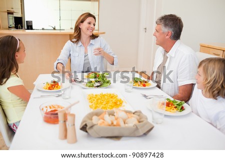 Cheerful family together at the dinner table