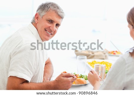 Side view of happy smiling mature man during dinner