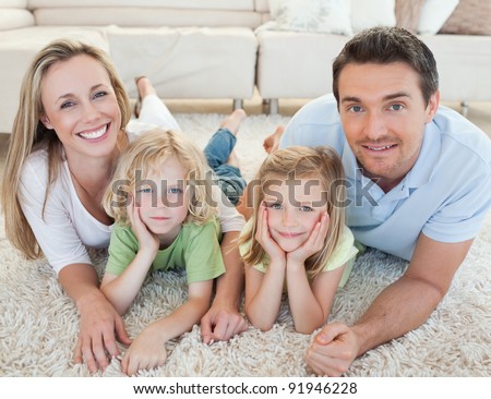 Family lying on the carpet together