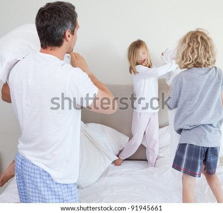 Playful family having a pillow fight together