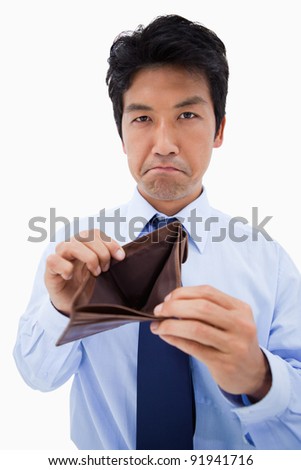 Portrait of a businessman showing his empty wallet against a white background