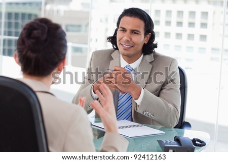 Happy manager interviewing a female applicant in his office