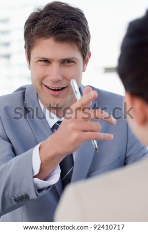 Portrait of a happy manager interviewing a female applicant in his office
