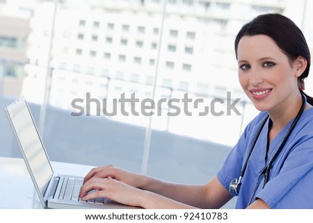 Doctor using a notebook in her office