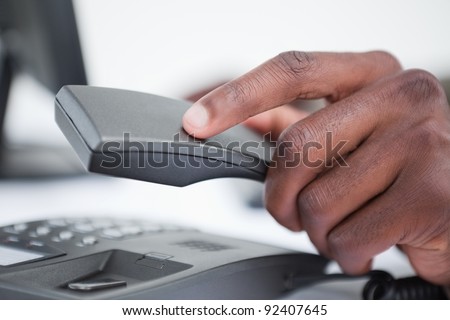 Close up of a hand hanging up against a white background
