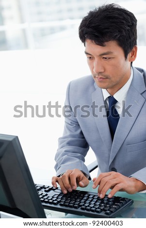 Portrait of a serious manager using a computer in his office