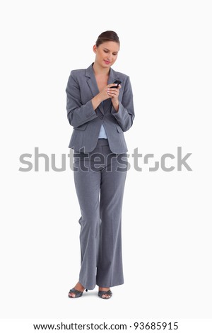 Tradeswoman writing text message against a white background